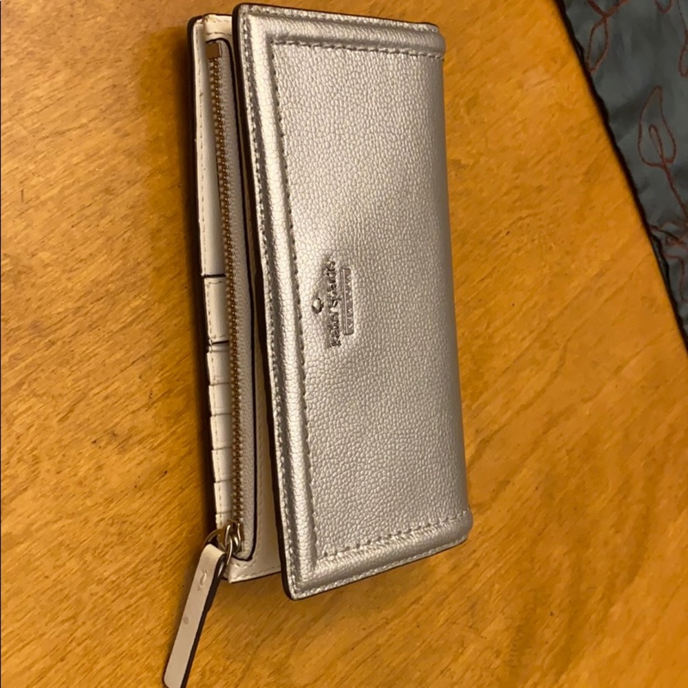 A silver Kate spade wallet! Lightly used.